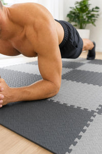 Man doing a plank on the interlocking gym floor mats